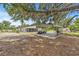 View of the backyard including a house, covered parking, and gym equipment at 2233 Rightaway Ln, Plant City, FL 33565