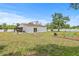 The backyard includes a house with an enclosed patio and garden beds at 2233 Rightaway Ln, Plant City, FL 33565