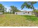 Spacious backyard featuring a well-maintained lawn and white-sided home at 2233 Rightaway Ln, Plant City, FL 33565