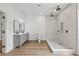 Modern bathroom boasts a large shower, gray vanity, and dual sink setup at 2233 Rightaway Ln, Plant City, FL 33565