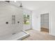 Bright bathroom features a marble shower, dual shower heads, and a view to outside at 2233 Rightaway Ln, Plant City, FL 33565