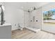 Modern bathroom with a large shower, white tile, and gray vanity with sink at 2233 Rightaway Ln, Plant City, FL 33565