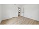 Bedroom showcasing light wood floors, white walls, and a doorway to a bathroom at 2233 Rightaway Ln, Plant City, FL 33565