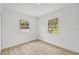 Bright bedroom with two windows and light wood flooring, creating a peaceful and airy space at 2233 Rightaway Ln, Plant City, FL 33565
