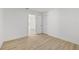 A bedroom has light wood flooring, white walls, and two doors in the corner at 2233 Rightaway Ln, Plant City, FL 33565