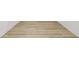 Close-up of light wood flooring against a white baseboard and white walls at 2233 Rightaway Ln, Plant City, FL 33565