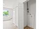 Bright hallway with wood flooring, white closets, and a window providing natural light at 2233 Rightaway Ln, Plant City, FL 33565