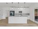 Modern kitchen with white cabinets, granite countertops, stainless steel appliances, and stylish pendant lighting at 2233 Rightaway Ln, Plant City, FL 33565
