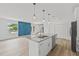 Bright open layout featuring granite island, pendant lighting and bold geometric accent wall at 2233 Rightaway Ln, Plant City, FL 33565
