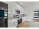 Updated kitchen features stainless steel appliances, modern backsplash, and granite countertops at 2233 Rightaway Ln, Plant City, FL 33565