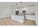Bright kitchen with white cabinets, granite counters, pendant lights, and an island, offering modern appeal at 2233 Rightaway Ln, Plant City, FL 33565