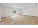 Bright and spacious living room features a double glass door and light wood floors at 2233 Rightaway Ln, Plant City, FL 33565