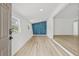 Bright living room with modern geometric accent wall and new hardwood flooring at 2233 Rightaway Ln, Plant City, FL 33565