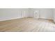 Bright living room with light wood flooring and white trim offers a modern aesthetic at 2233 Rightaway Ln, Plant City, FL 33565