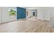 Open-concept living area with large windows, light wood floors, and a unique accent wall at 2233 Rightaway Ln, Plant City, FL 33565