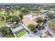 Aerial view of community clubhouse featuring a pool, tennis courts, bocce ball, golf course, and lush landscaping at 2238 Lark W Cir # D, Palm Harbor, FL 34684