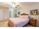 Cozy bedroom with wicker accents and ensuite bathroom access, offering both comfort and convenience at 2238 Lark W Cir # D, Palm Harbor, FL 34684