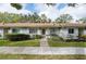 Charming one-story townhome with a well-maintained front lawn and stone facade and concrete pathway at 2238 Lark W Cir # D, Palm Harbor, FL 34684