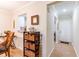 Inviting hallway featuring a white front door, a breakfast bar, and a storage rack at 2238 Lark W Cir # D, Palm Harbor, FL 34684