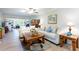 Open-concept living room featuring hardwood floors, bright walls, and modern furniture at 2238 Lark W Cir # D, Palm Harbor, FL 34684