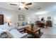 Open-concept living room and dining area featuring tile floors, neutral walls, and modern furnishings at 2238 Lark W Cir # D, Palm Harbor, FL 34684