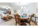 Inviting living room and dining area featuring tile floors, neutral walls, and modern furnishings at 2238 Lark W Cir # D, Palm Harbor, FL 34684