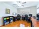Bright home office with hardwood floors, plantation shutters, and an expansive desk area at 2238 Lark W Cir # D, Palm Harbor, FL 34684