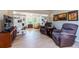 Bright sun room featuring hardwood floors, neutral walls, and modern furniture at 2238 Lark W Cir # D, Palm Harbor, FL 34684