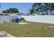 A fenced backyard with grass and concrete features, ideal for outdoor activities and storage at 2603 Mary Sue Sw St, Largo, FL 33774