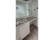Vanity with a sink, large mirror, storage and marble-like tile flooring at 2603 Mary Sue Sw St, Largo, FL 33774