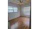 Bedroom with two windows, laminate flooring, a ceiling fan, and white walls at 2603 Mary Sue Sw St, Largo, FL 33774