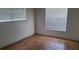 Bright and airy bedroom with wood floors, natural light, and electrical outlets at 2603 Mary Sue Sw St, Largo, FL 33774