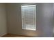 Bright bedroom featuring wood flooring and a window with bright sunlight shining through blinds at 2603 Mary Sue Sw St, Largo, FL 33774