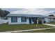 Charming single-story home with a well-maintained lawn, bright blue trim and a front-facing garage at 2603 Mary Sue Sw St, Largo, FL 33774