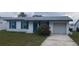 Charming single-story home with a well-maintained lawn, bright blue trim and a front-facing garage at 2603 Mary Sue Sw St, Largo, FL 33774