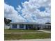 Inviting front of home with blue shutters, simple landscaping, and driveway parking at 2603 Mary Sue Sw St, Largo, FL 33774