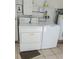 Laundry area includes a washer and dryer, as well as a water heater at 2603 Mary Sue Sw St, Largo, FL 33774