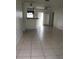 Spacious living room features tile flooring and access to an outdoor patio at 2603 Mary Sue Sw St, Largo, FL 33774
