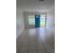 Bright living room with tile flooring, a front door and a window allowing for natural light at 2603 Mary Sue Sw St, Largo, FL 33774
