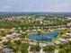 High aerial of the home, property and surrounding homes next to a pond in a desirable neighborhood at 2730 River Woods Dr, Parrish, FL 34219