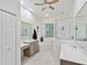 This well-lit bathroom features a separate tub and shower, plus dual sink vanities and a neutral tile floor at 2730 River Woods Dr, Parrish, FL 34219