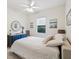 Bright bedroom with white walls, ceiling fan, neutral carpet, and a medium window with white shade at 2730 River Woods Dr, Parrish, FL 34219
