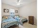 Cozy bedroom featuring twin beds with decorative blue and gold bedding plus an adjacent chest of drawers at 2730 River Woods Dr, Parrish, FL 34219
