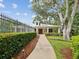 Community clubhouse with a welcoming entrance, lush landscaping, and well-maintained walkway at 2730 River Woods Dr, Parrish, FL 34219