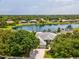 Beautiful waterfront home with lush landscaping and scenic lake views from an aerial perspective at 2730 River Woods Dr, Parrish, FL 34219