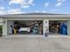 Spacious three car garage, with ample storage and organization, containing multiple parked vehicles at 2730 River Woods Dr, Parrish, FL 34219