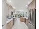 Modern kitchen featuring stainless steel appliances, updated cabinetry, and a seamless layout to dining area at 2730 River Woods Dr, Parrish, FL 34219