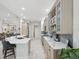 Open kitchen with stainless steel appliances, quartz countertops, and a large island with seating at 2730 River Woods Dr, Parrish, FL 34219