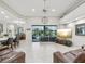Spacious living room with tile flooring, large windows with a pool view, and modern decor at 2730 River Woods Dr, Parrish, FL 34219