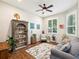 Cozy living room with hardwood floors, a comfortable couch, and a large window for natural light at 2730 River Woods Dr, Parrish, FL 34219
